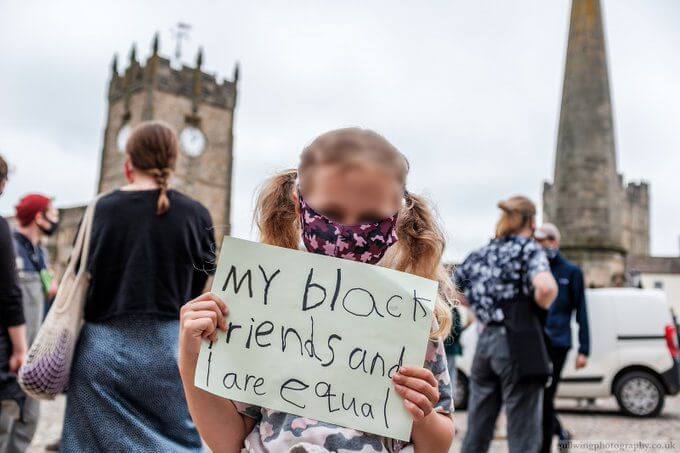 Young girl holding protest sign