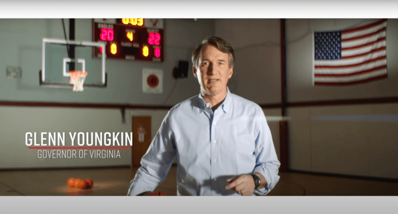 Virginia Governor Glenn Youngkin standing in a basketball court