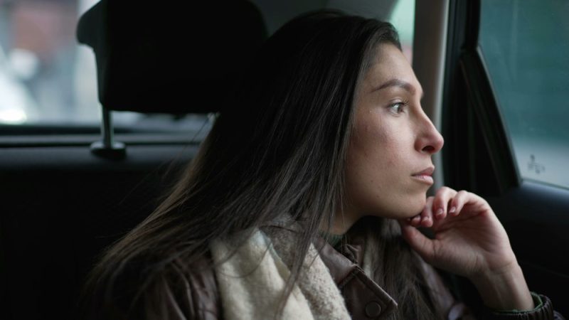 Portrait of woman in car staring out the window.