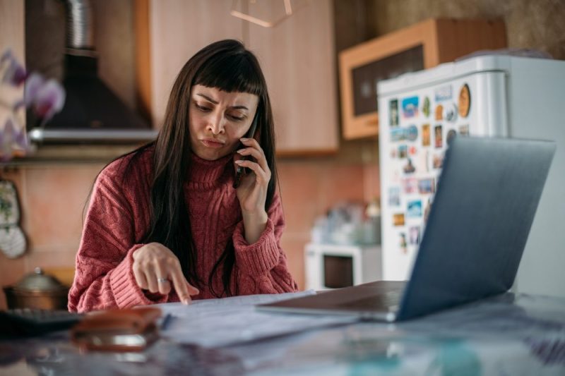 Photo of a woman going over her utility bills.